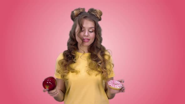 Beautiful Young Girl in a Yellow Tshirt Makes a Choice in Favor of Healthy Products and Smiling