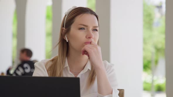 Portrait of Serious Focused Woman Working on Laptop Computer Looking Away RED