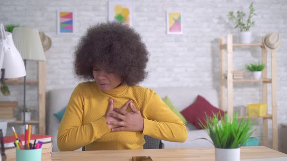 Beautiful African American Woman with an Afro Hairstyle Unexpected Attack or Heart Pain Takes a Pill