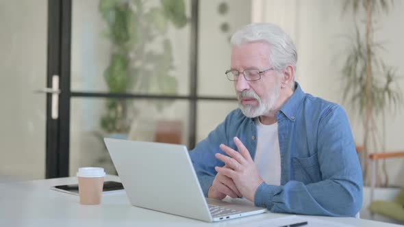 Senior Old Man Talking on Video Call on Laptop in Office