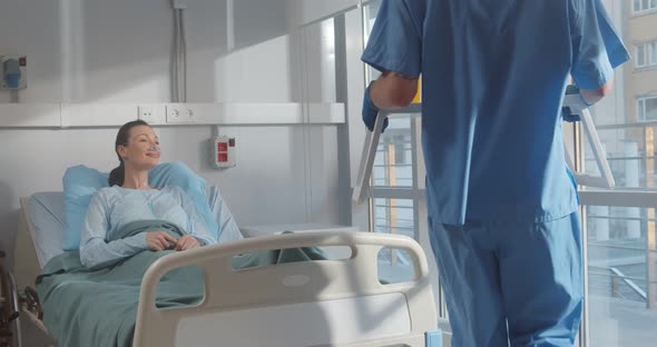 Female Patient with Nasal Oxygen Tube Enjoying Meal in Hospital Bed