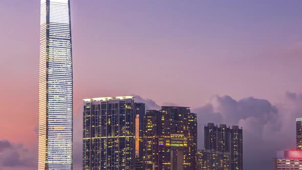 Hong Kong Business Center Day to Night Timelapse with a Cloudy Blue Sky Before Sunset