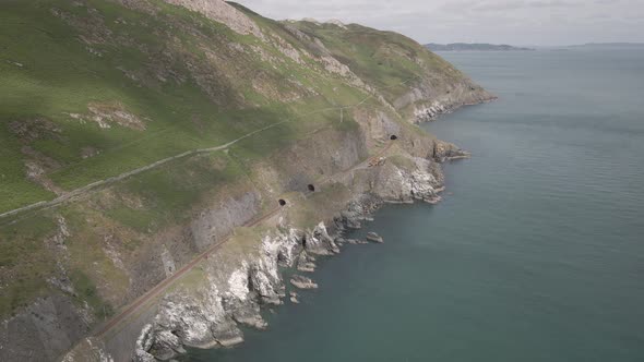 Railway Tracks On The Cliffs  Passing Through The Tunnel At Bray Head Mountain In Wicklow, Ireland.