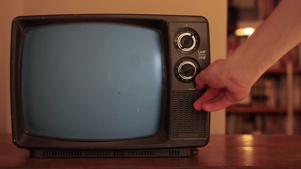 Male Hand Turning On A Retro TV Green Screen.