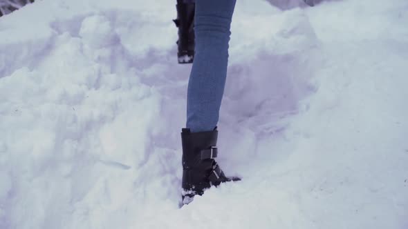 Young Girl Walking in Deep Snow Outdoors During Holidays