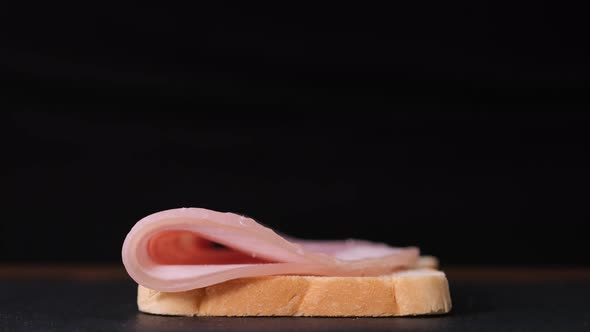 Preparation of sandwich with ham. Chef is cooking sandwich with prosciutto cotto