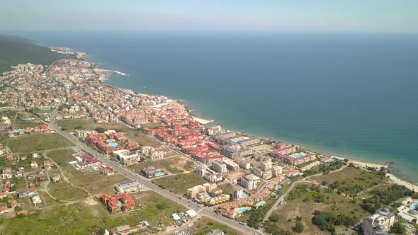Aerial view of Sunny Beach city that is located on Black Sea shore. Top view of sand beaches with