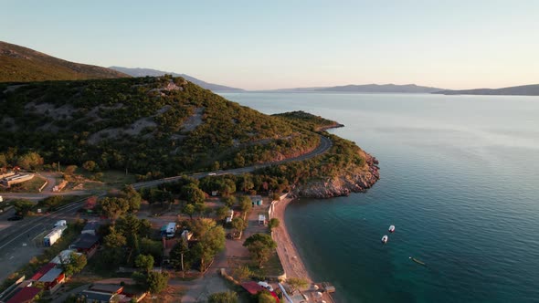 Aerial View of the Rocky Coast of Croatia with a Curve Road at Sunset Time