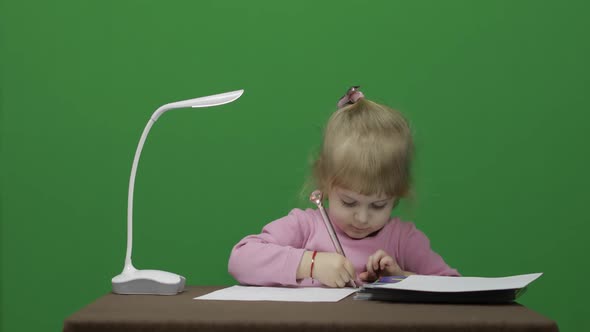 Girl Drawing at the Table. Education Process. Three Years Old Child. Chroma Key