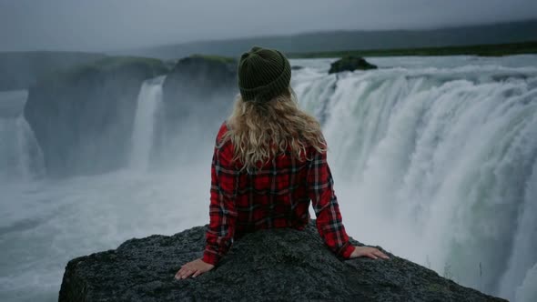 Woman Traveller at Waterfall in Iceland or Norway