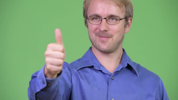 Head Shot of Happy Handsome Blonde Businessman Giving Thumbs Up