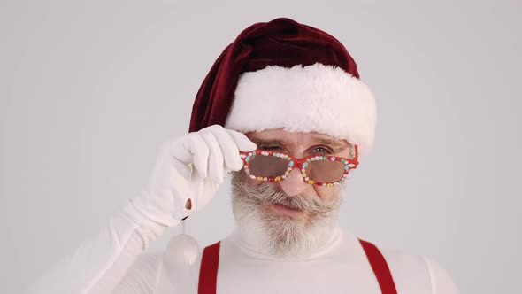 Smiling Gray-haired Santa Claus Man in Christmas Hat and Suspenders Isolated on Vwhite Background