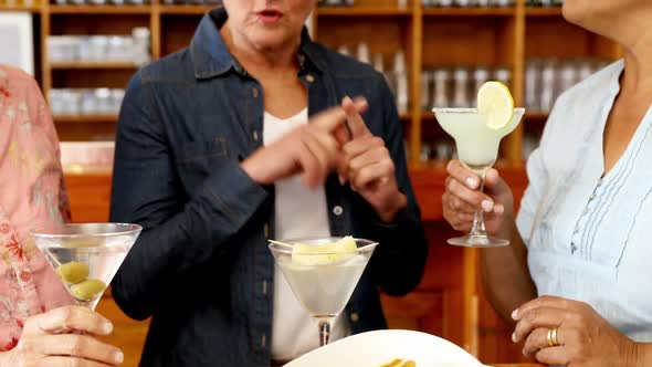 Senior friends toasting glass of cocktail 4k