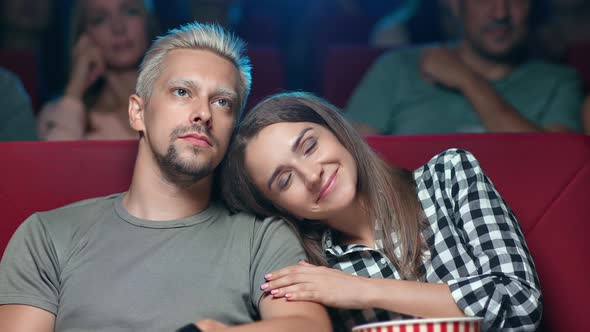 Enamored Man and Woman Smiling Watching Melodrama Film at Cinema Hugging Having Romantic Date