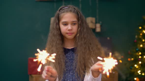 Cheerful Little Girl Playing with Sparklers at Xmas
