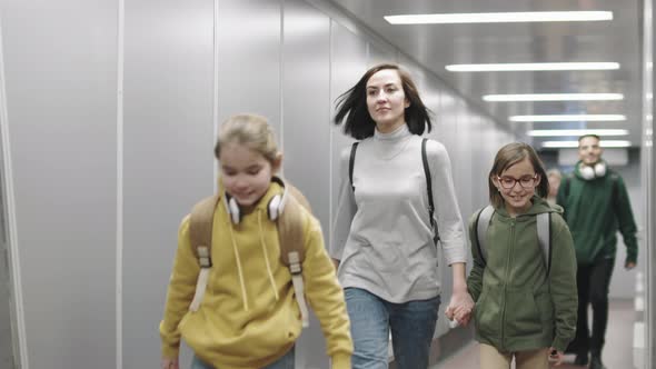 People Walking Down Corridor Boarding On Plane