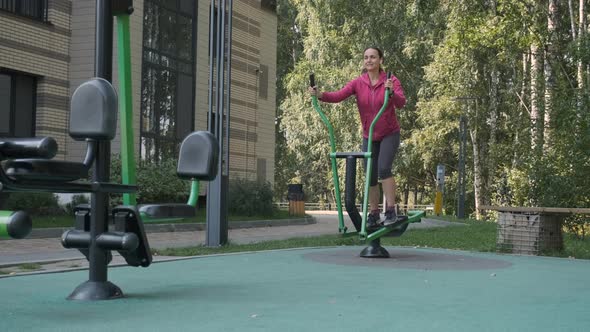 Sporty Female Doing Work Out in an Outdoors Gym