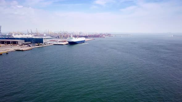 Aerial view of logistics concept cargo ship sailing out to the open sea leaving Laem Chabang dockyar