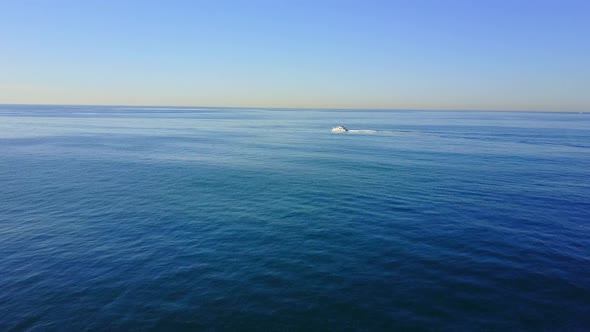 Aerial drone uav view of a motor boat and the ocean.