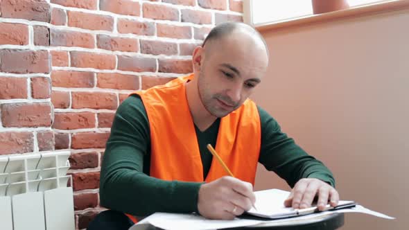 Construction engineer works with blueprints in the office.