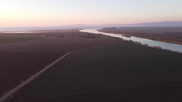 Salinas River turn near Castroville surrounded by vast agriculture farmland, aerial drone view