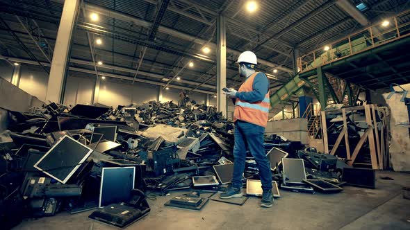 Male Engineer is Observing a Landfill Unit Filled with Rubbish