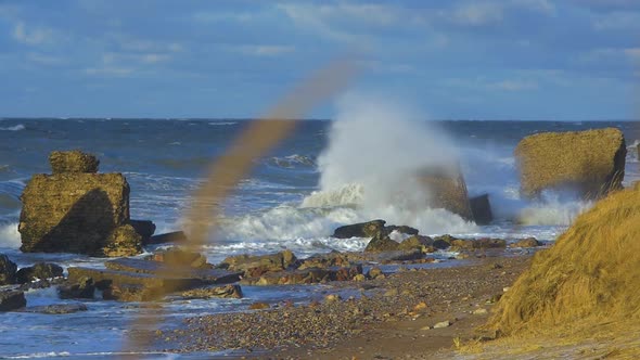 Big stormy waves breaking against abandoned Karosta Northern Forts ruins and Baltic sea coastline at