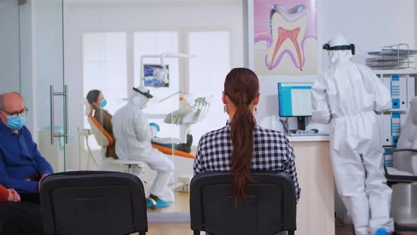 Assistant with Ppe Suit Coming in Reception