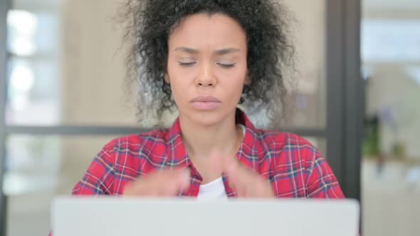 Close Up of African Woman Having Headache While Using Laptop
