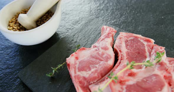 Rib chop, spice and herbs on concrete background