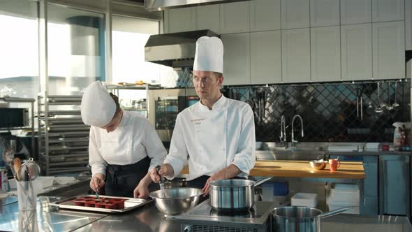 Milk is churned in a professional restaurant kitchen. Dessert cooking.