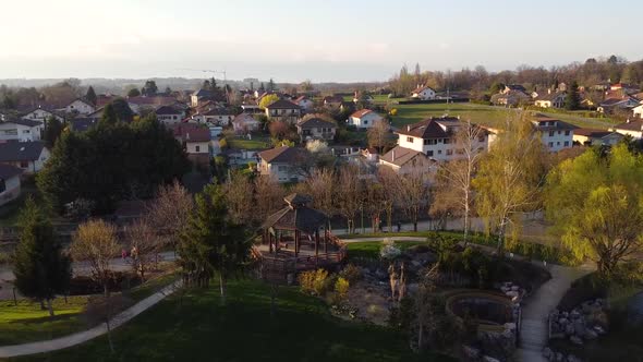 Drone Shot of a Small Park with a Wooden Shelter above a Waterfall