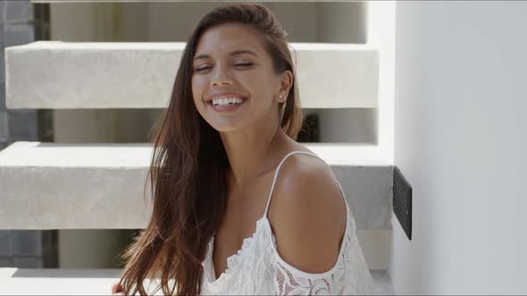 Happy Beautiful Woman Sitting on Stairs