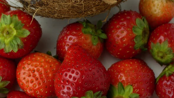 Rotation of juicy strawberries and coconut. Top view, 360 degree rotation, extreme close-up.