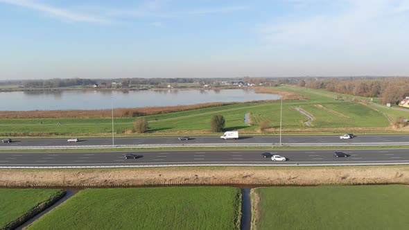 Aerial: highway slider tracking view alongside road, European countryside