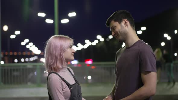 Loving Boyfriend Talking with Girlfriend in Slow Motion Standing Outdoors in Night City