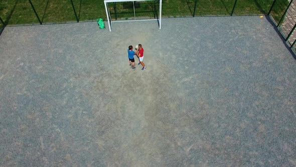 Children playing on playground. Top down aerial view of children playing on sports field