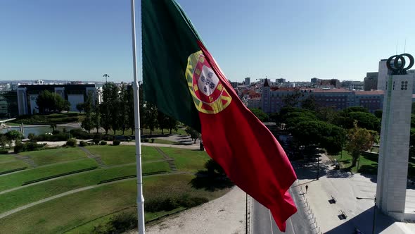 Close Up Aerial View of Portugal Flag Waving in the Wind on Eduardo VII Park Lisbon