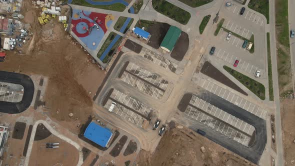 Flight Over The Construction Site. Filmed With The Camera Down. alt