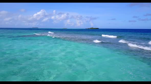 Aerial nature of relaxing shore beach break by aqua blue ocean with white sand background of a dayou