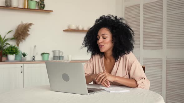 Cute African American Woman Communicates on a Video Call Using a Mobile Phone