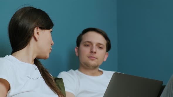 Family Work From Home Woman Using a Laptop and Man Using a Smatphone