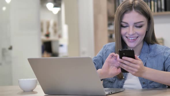 Creative Woman Browsing Internet and Using Smartphone