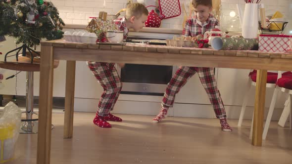 Happy Brothers Dancing at the Kitchen on Christmas Time