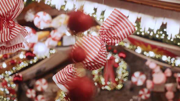 A Large Christmas Decoration in the Form of Candy Hangs in a Beautiful House or