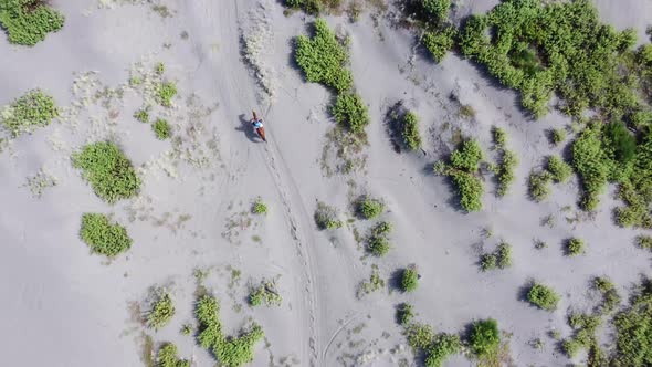 Adventurers on horseback through desert areas. Top View. Aerial drone view flight.