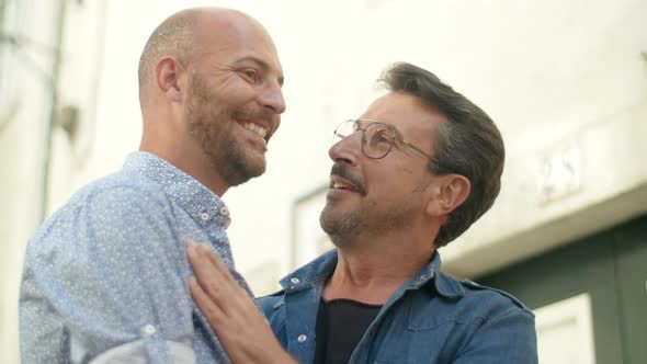 Medium Shot of Happy Guys Touching Each Other with Tenderness