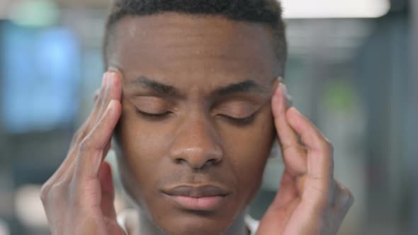 Close up of African Man having Headache