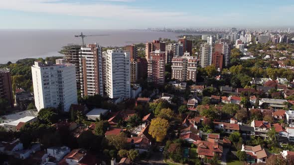 Ascending aerial shot of San Isidro residential area in Buenos Aires with apartment blocks along coa