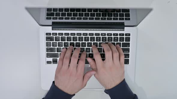 Top View of Hands Typing on Laptop